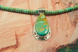 Genuine Royston Turquoise set in Sterling Silver Pendant on a Beautiful Necklace featuring Genuine Royston Turquoise Rondelle Beads. Sterling Silver Extender,  Beads and Clasp. Created by Navajo Artist Phillip Sanchez. The Royston Turquoise Mine is located in Nye County, Nevada.  